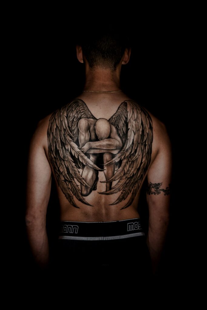 Kneeling angel with wings memorial back tattoo