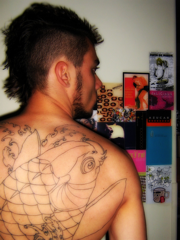 Koi fish back tattoo in outline on a man