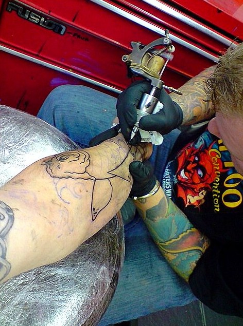 Koi fish tattoo outline being started on the leg
