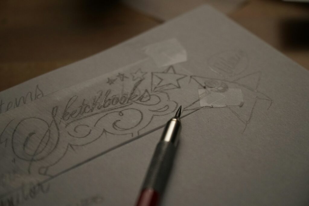 Hand lettering design drawn on paper before tattooing