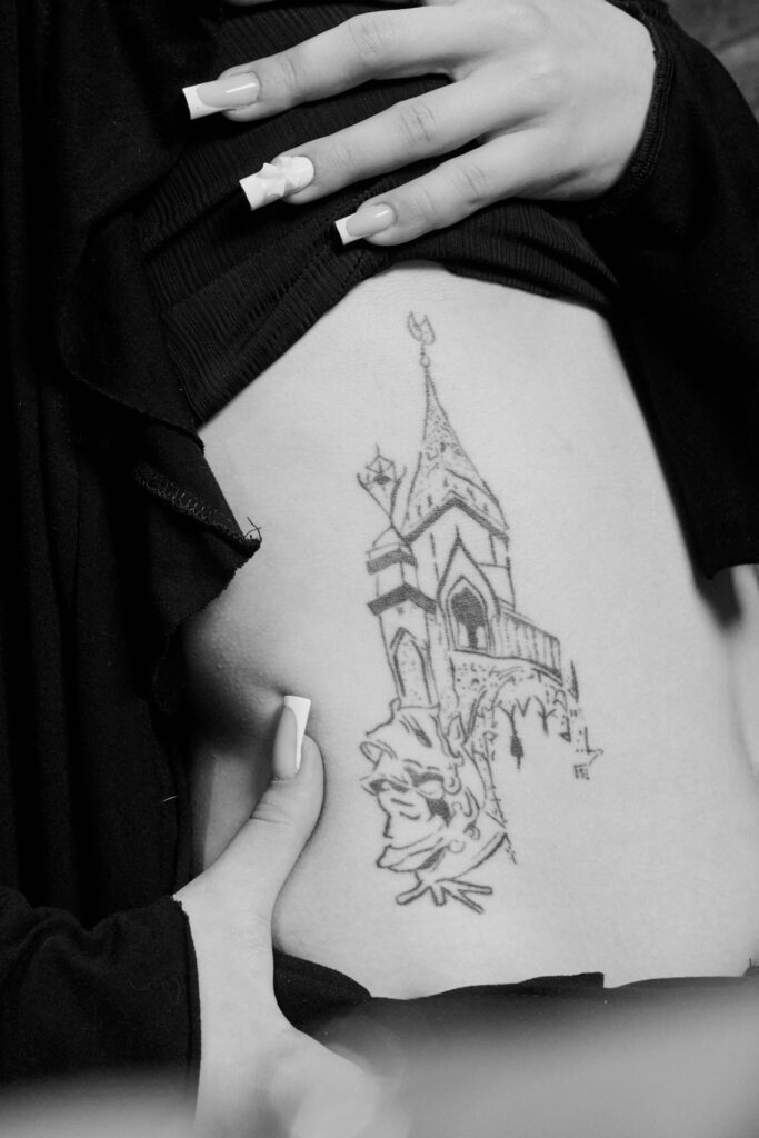 Fine line art tattoo on the ribs