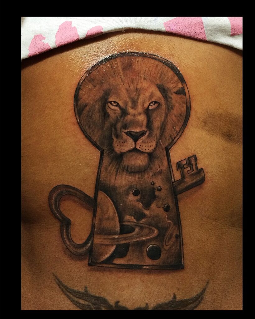 Lion inside a keyhole with a key tattoo