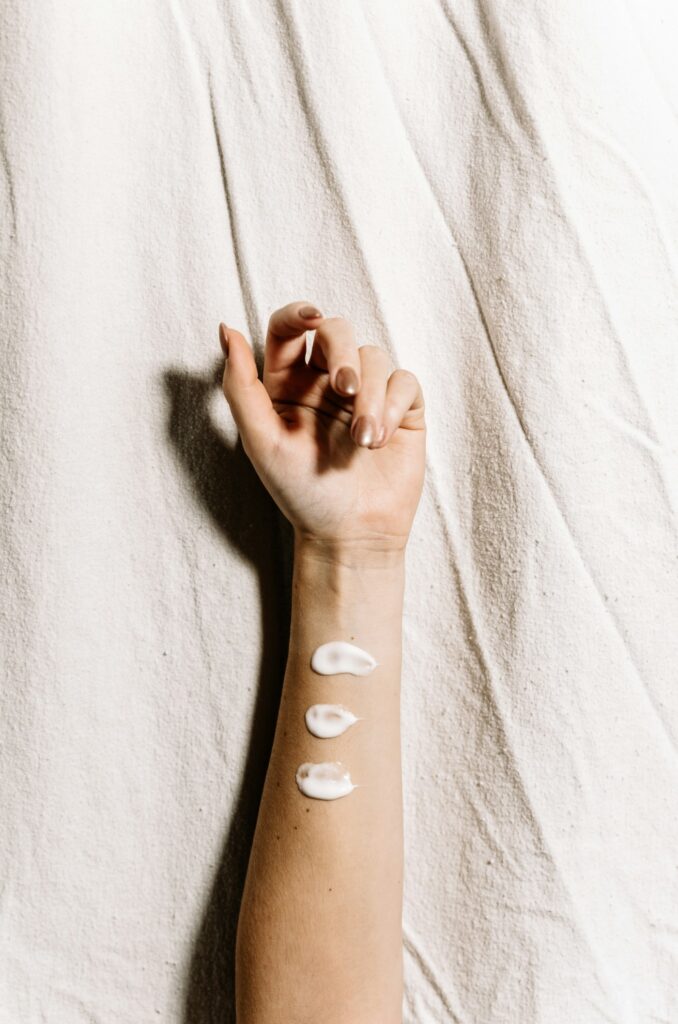 Small dots of lotion on the arm before moisturizing