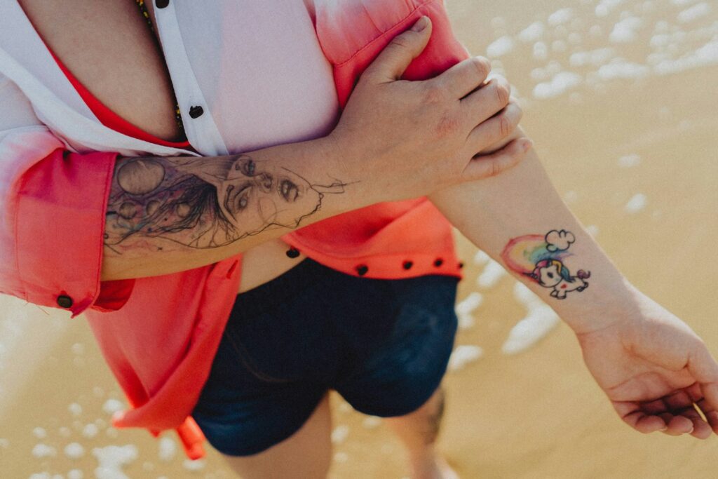 Woman with tattooed forearms in denim shorts
