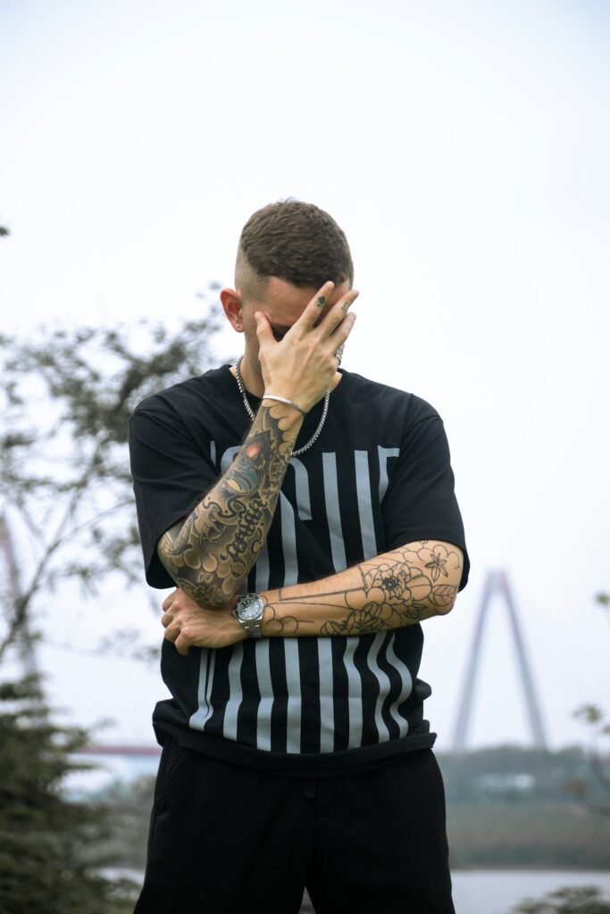 Lower half sleeve on a man in a striped shirt