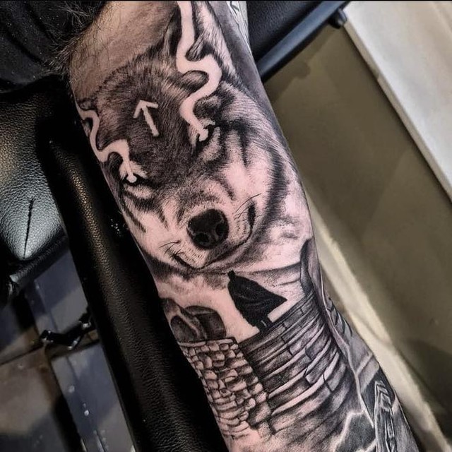 Man and wolf black and white biceps tattoo