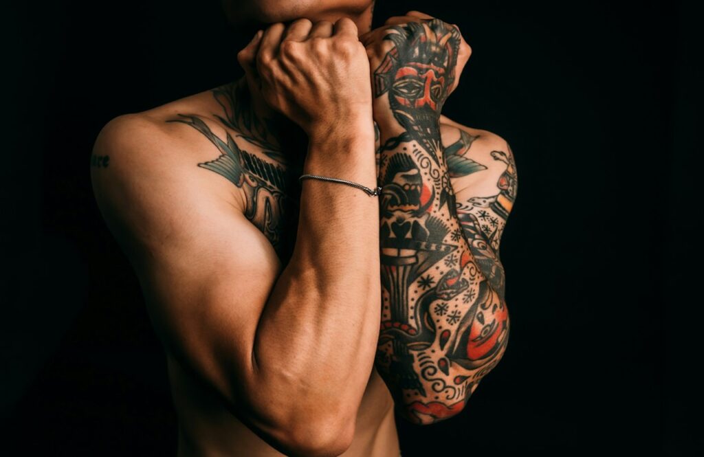 Man showing arm and forearm tattoos
