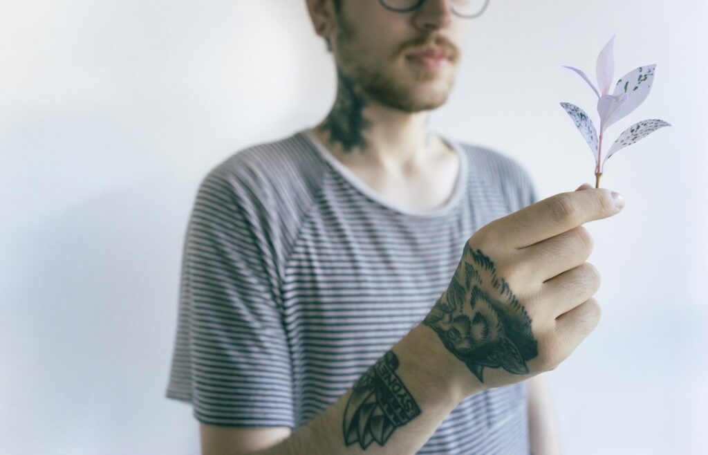 Man with tattoos on his forearm in natural light