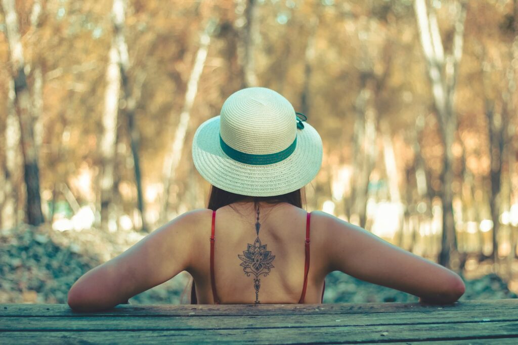 Mandala and dot work spine tattoo on a woman