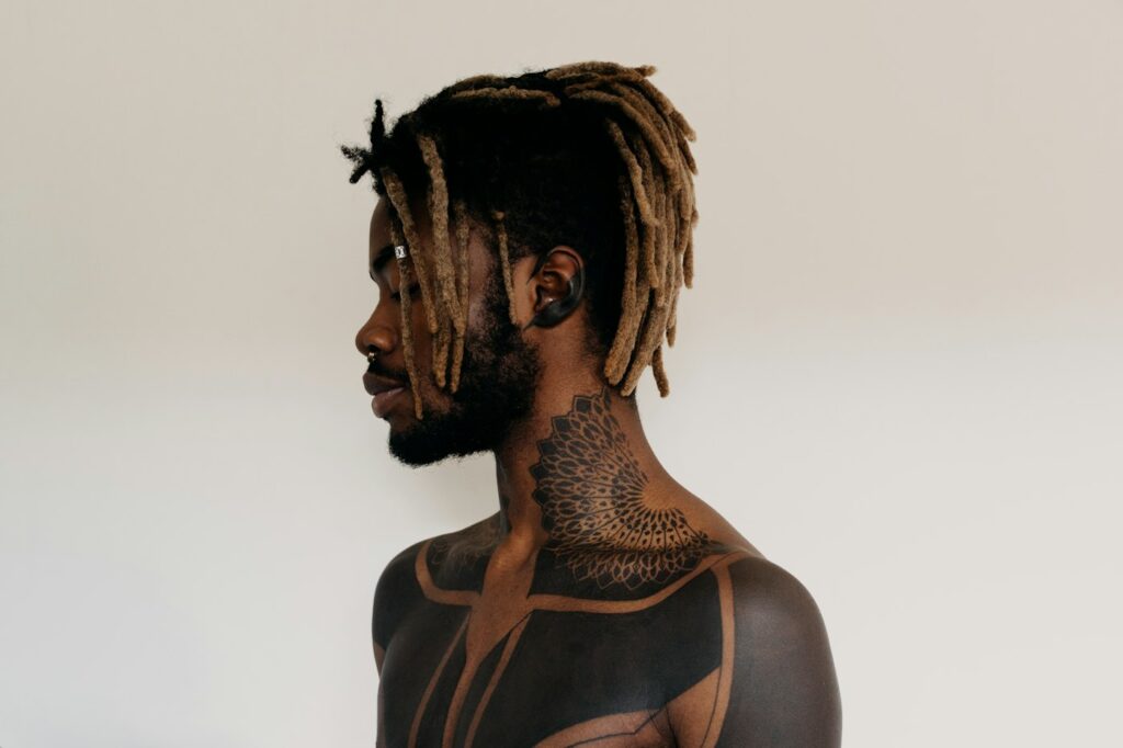 Mandala style throat tattoo on a man