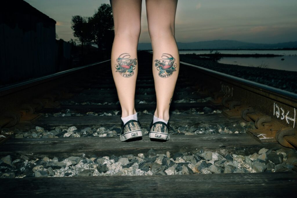 Matching tattoos on the backs of both calves