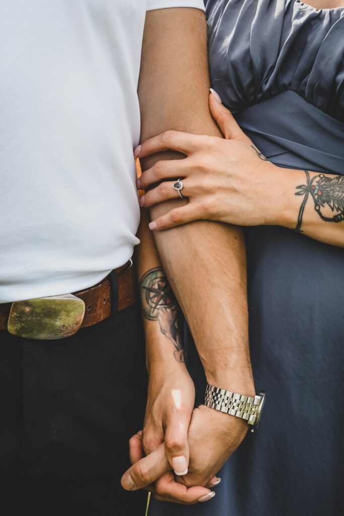 Couple showing matching tattoos on their arms