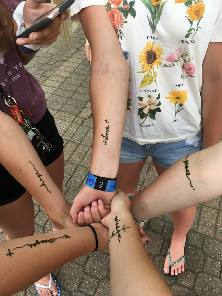 Family tattoo ideas: four people with matching script tattoos