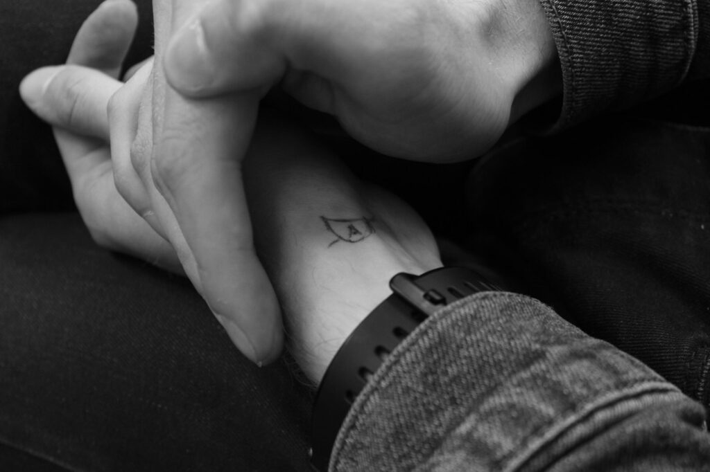 Geometric tattoo: minimal line symbol on the inner arm