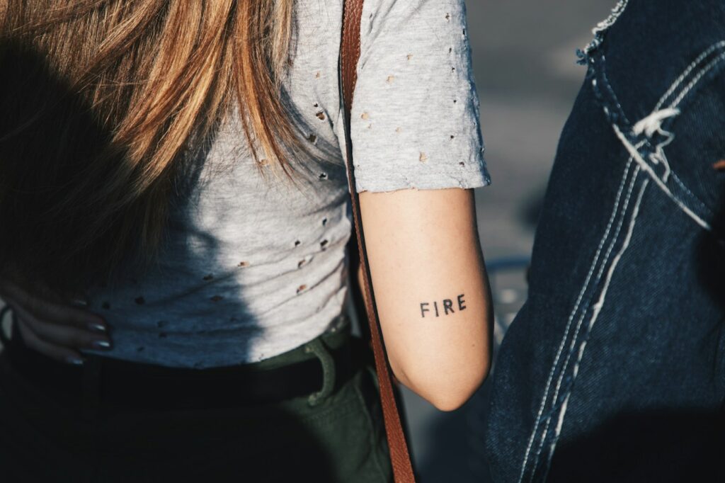 Minimalist single word script tattoo on the arm