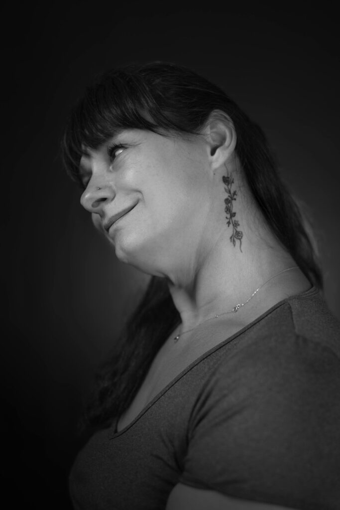 Woman with a neck tattoo looking up