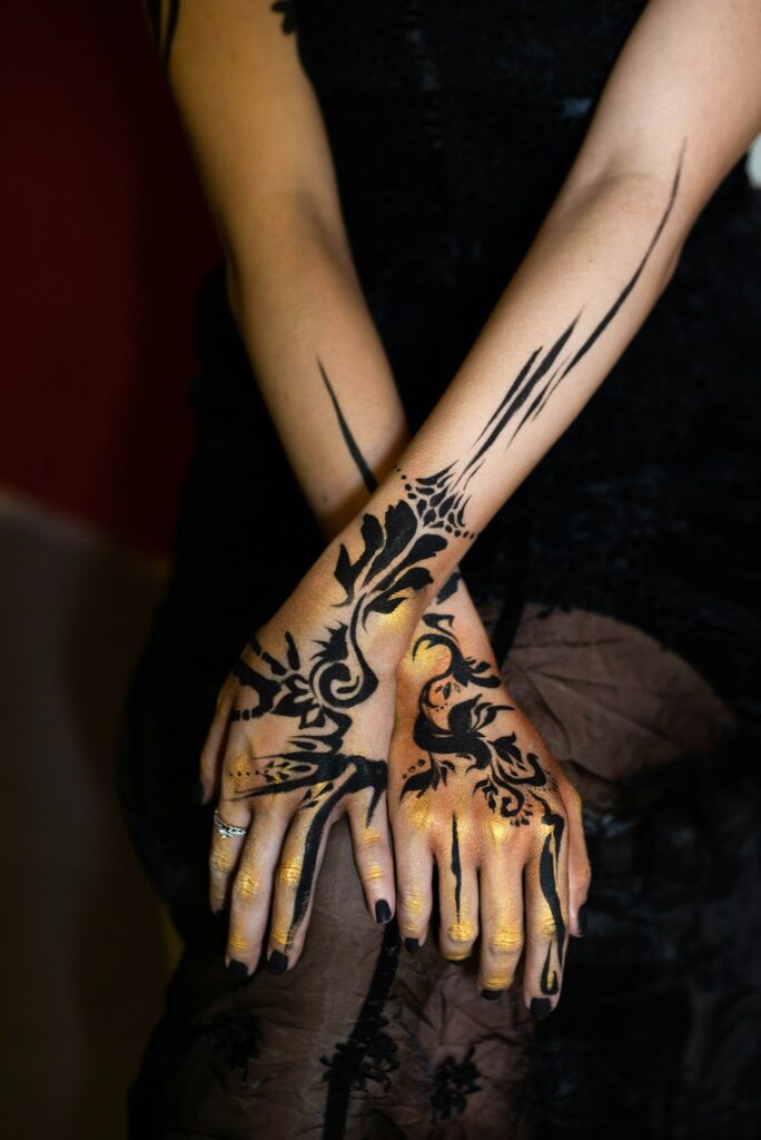 Neo tribal tattoos on the hands and forearms