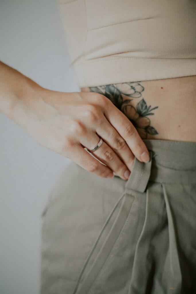 Older floral tattoo on a woman's hip