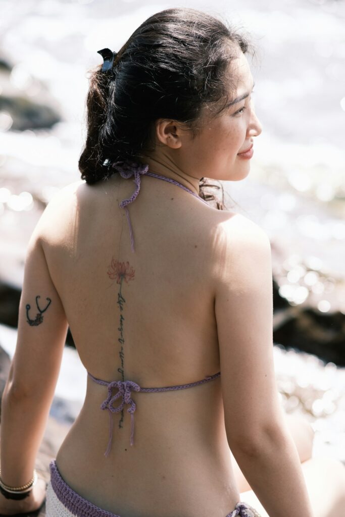 Ornamental tattoo running down the spine