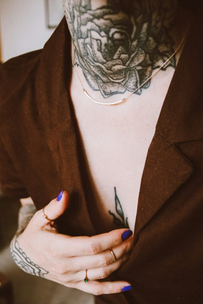 Ornamental throat and chest tattoo on a woman