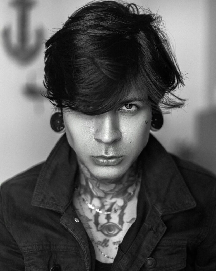 Ornamental throat tattoo on a man in black and white