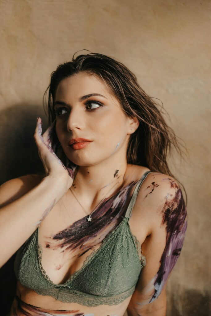 Painterly color tattoo across a woman's chest and shoulder