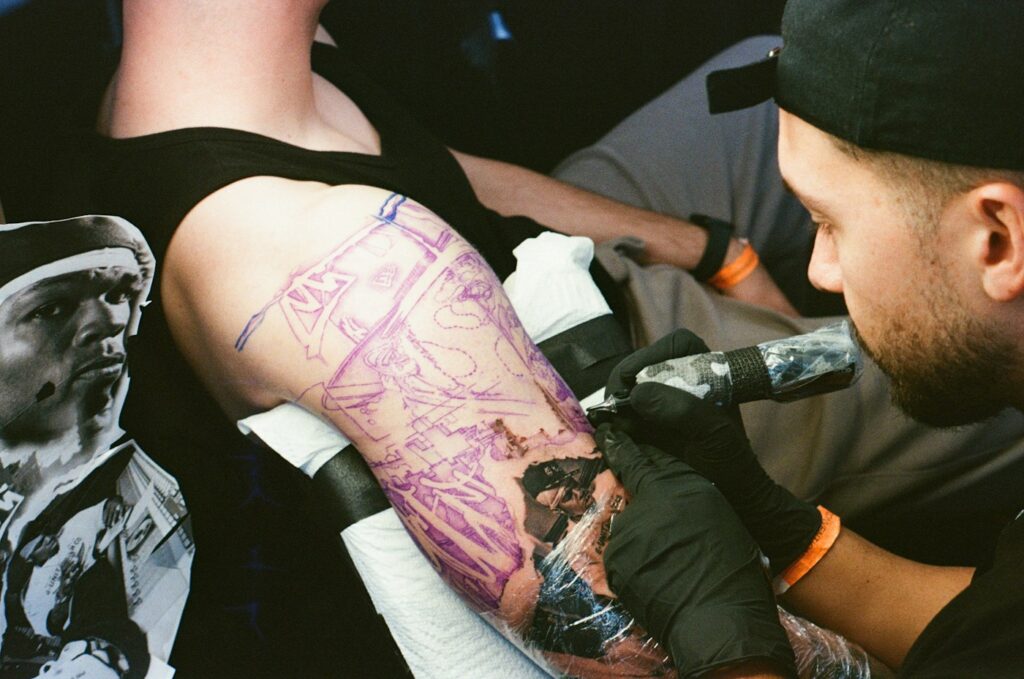 Pastel watercolor arm tattoo being inked