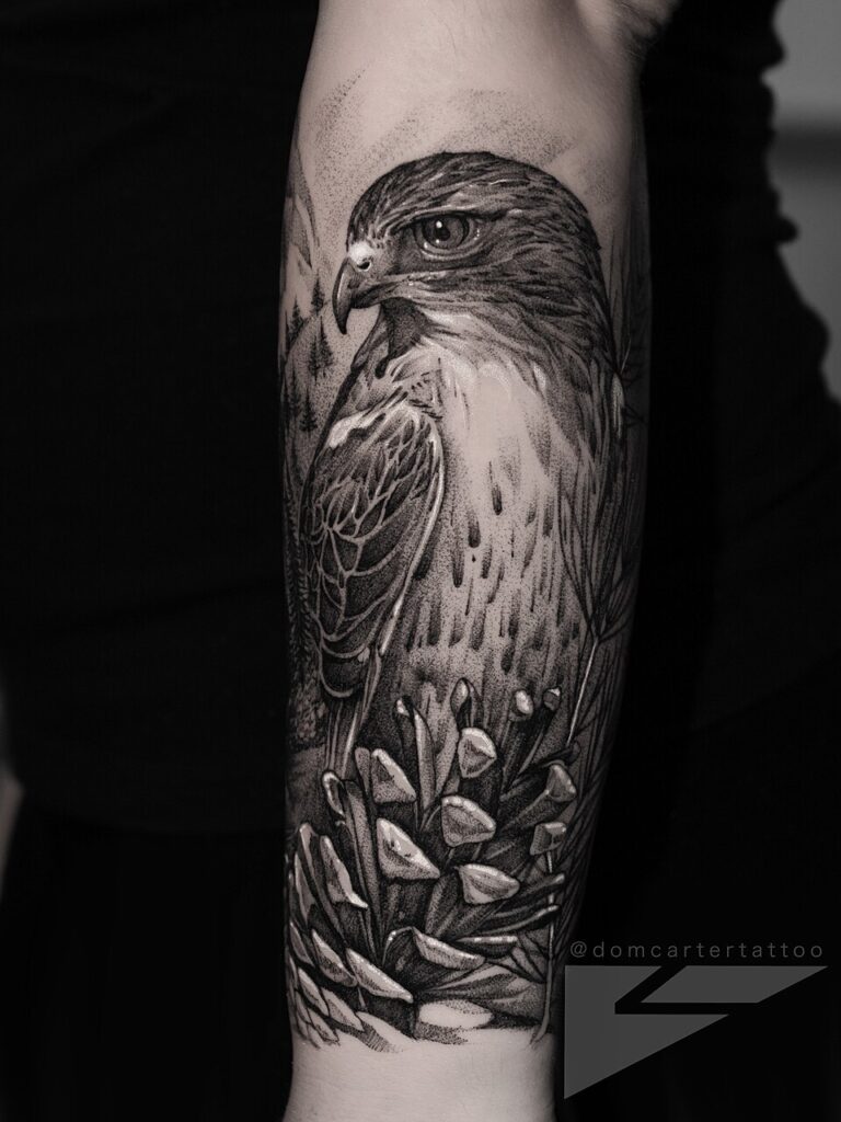 Perched eagle with flowers in black and grey on the upper arm