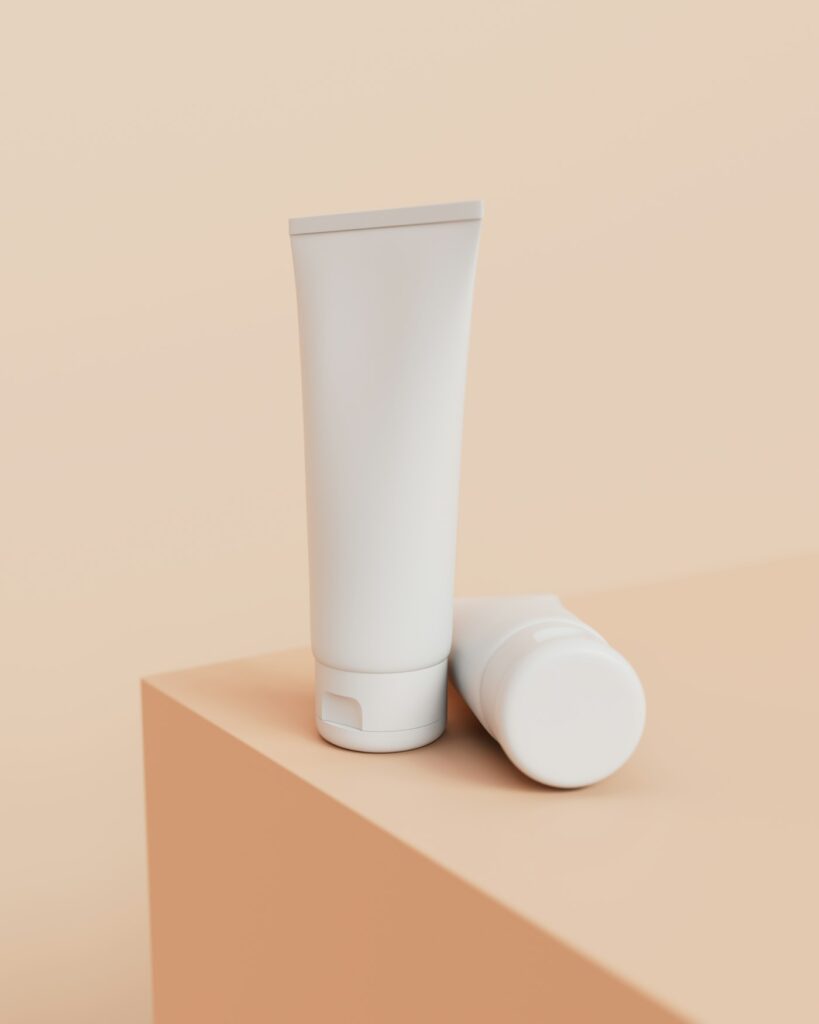 Plain white cream tube on a beige block