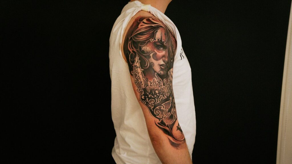 Realistic portrait tattoo on a man's upper arm