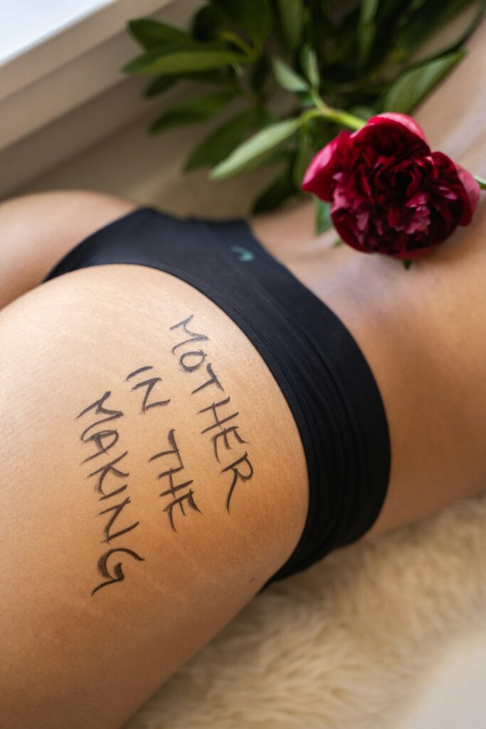 Quote tattoo on a woman's hip and upper thigh