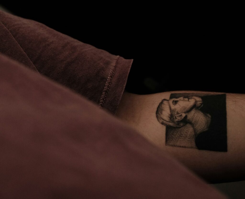 Black and grey realism portrait tattoo on the arm