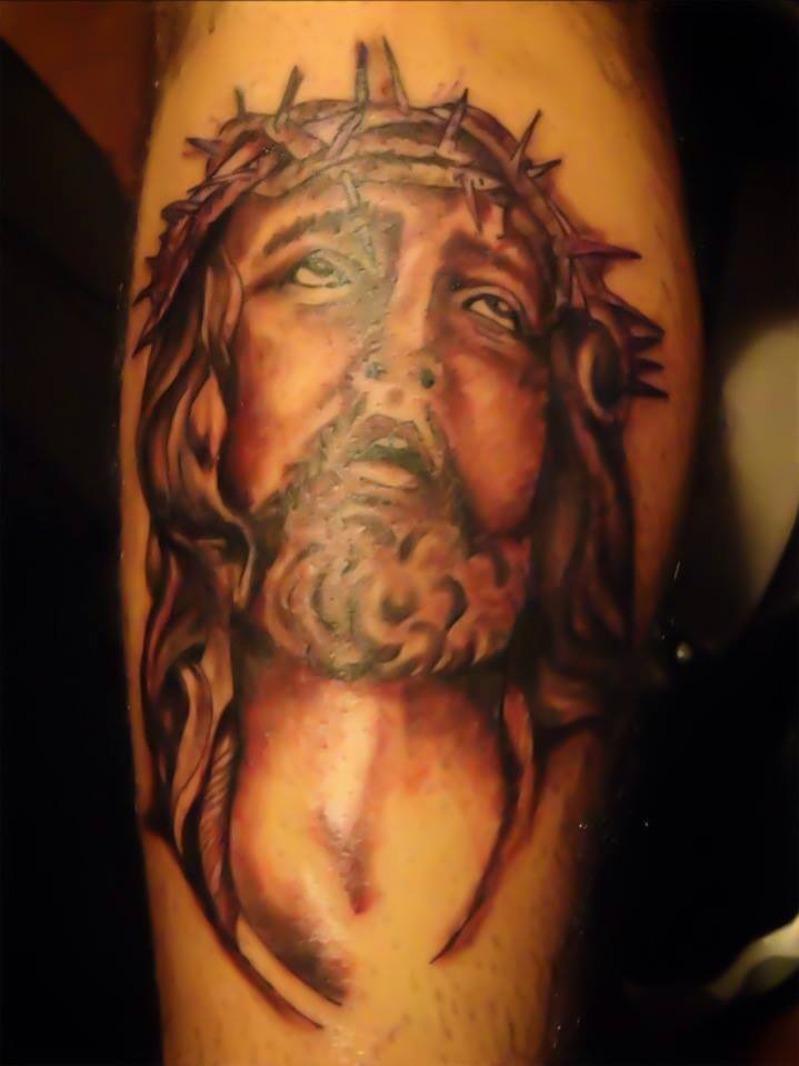 Realistic Jesus face tattoo with crown of thorns