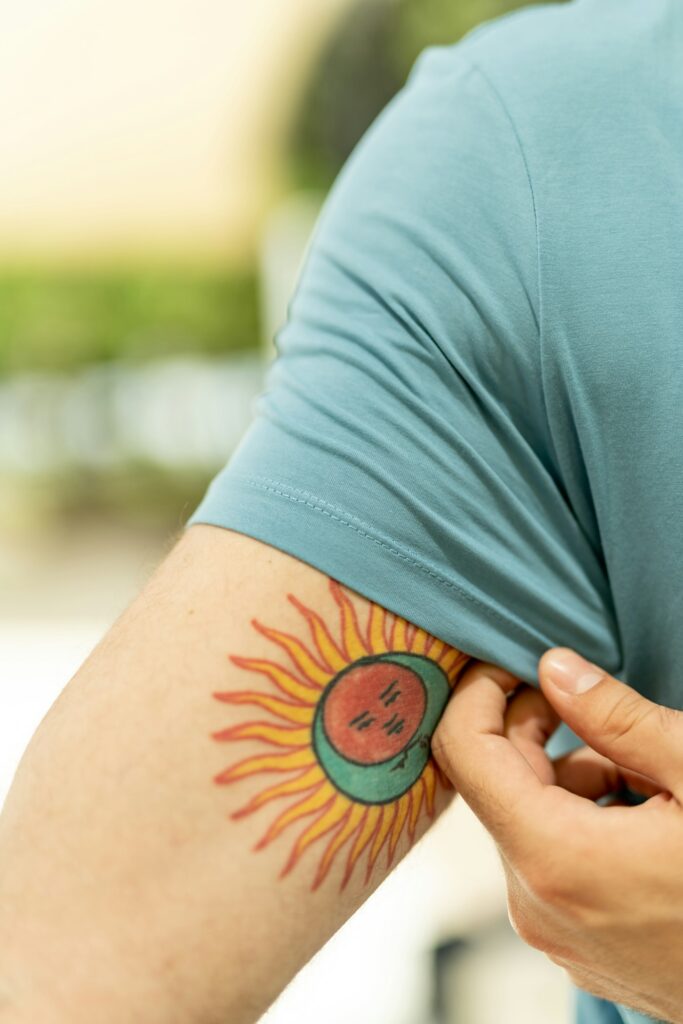 Removing a protective film from a fresh color sun tattoo