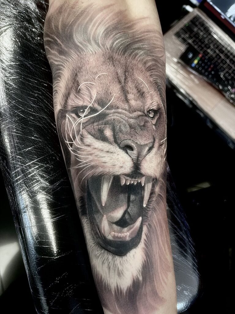 Realistic roaring lion tattoo