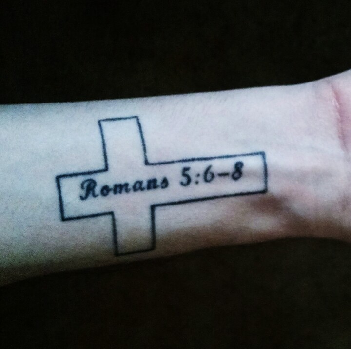 Cross tattoo with the Bible verse Romans 5:6-8