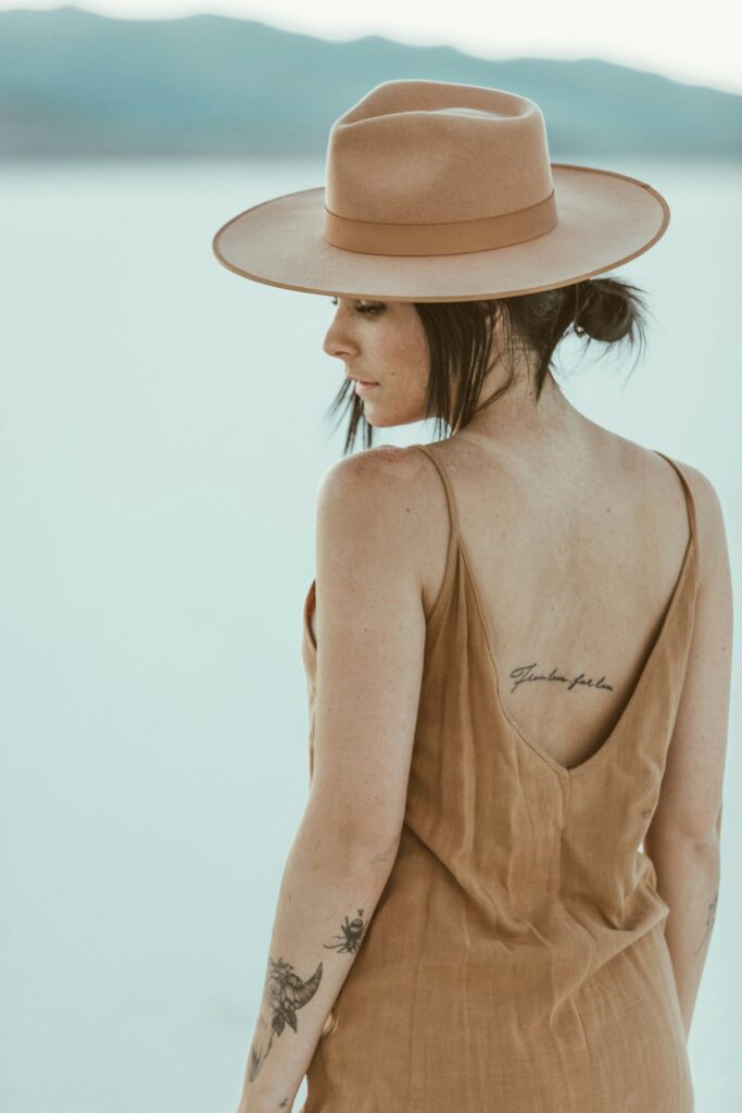 Fine script tattoo across a woman's mid back
