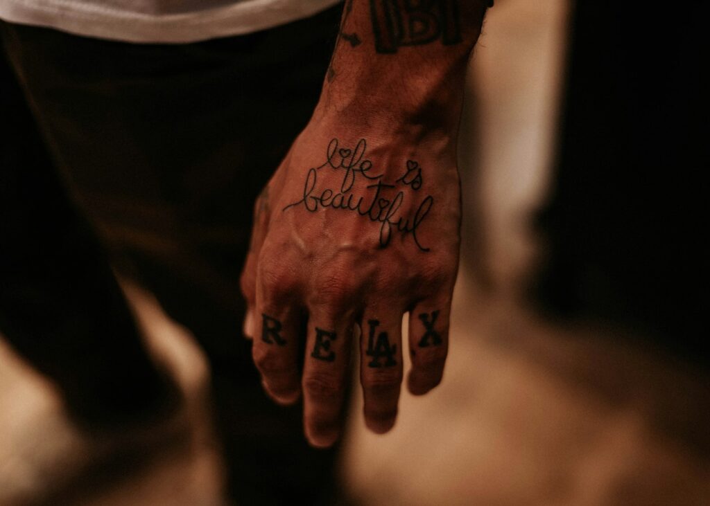 Script on the back of the hand with letters on the fingers