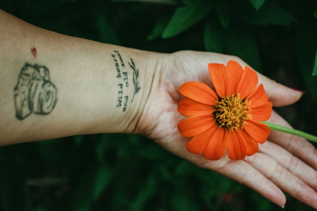 Handwritten script and a small sketch on the inner forearm