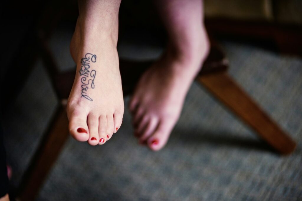 Script tattoo on the top of a woman's foot