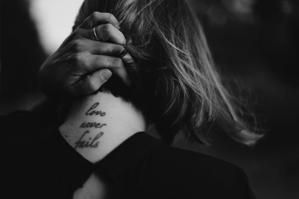 Script tattoo on the side of a woman's neck
