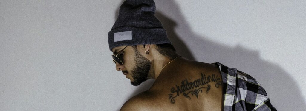 Back tattoos for men: script across the upper back below the neck