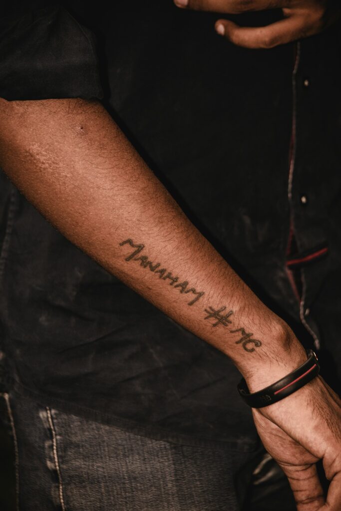 Script tattoo on the wrist above a bracelet