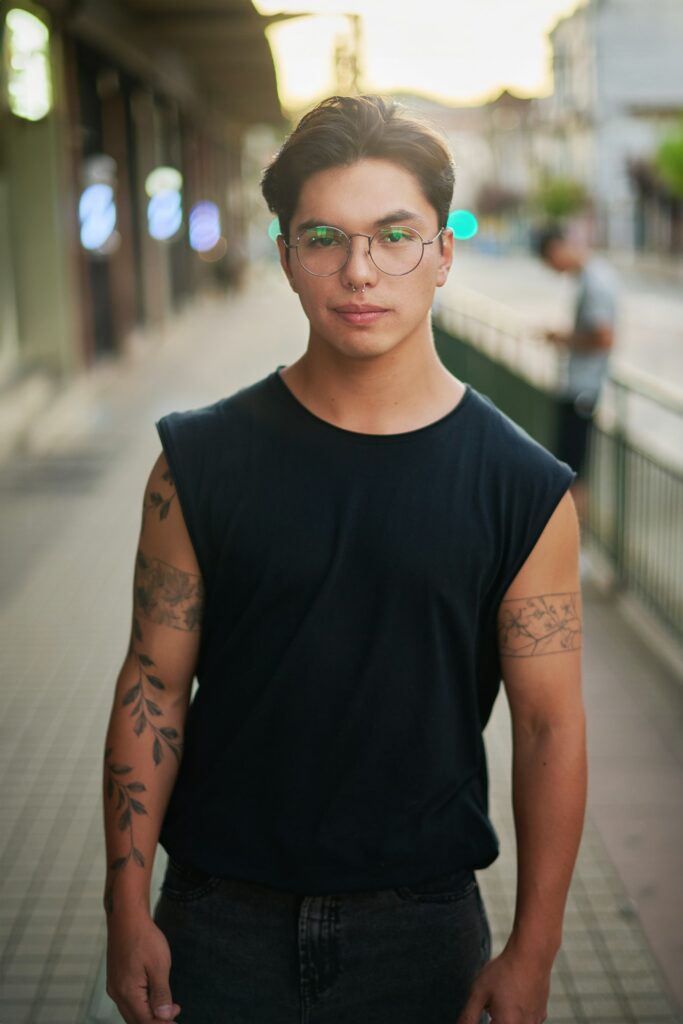 Shoulder tattoos for men: man in a sleeveless shirt with shoulder and arm tattoos