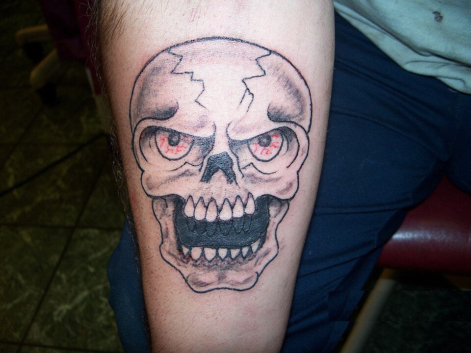 Black and grey skull tattoo used as a cover up