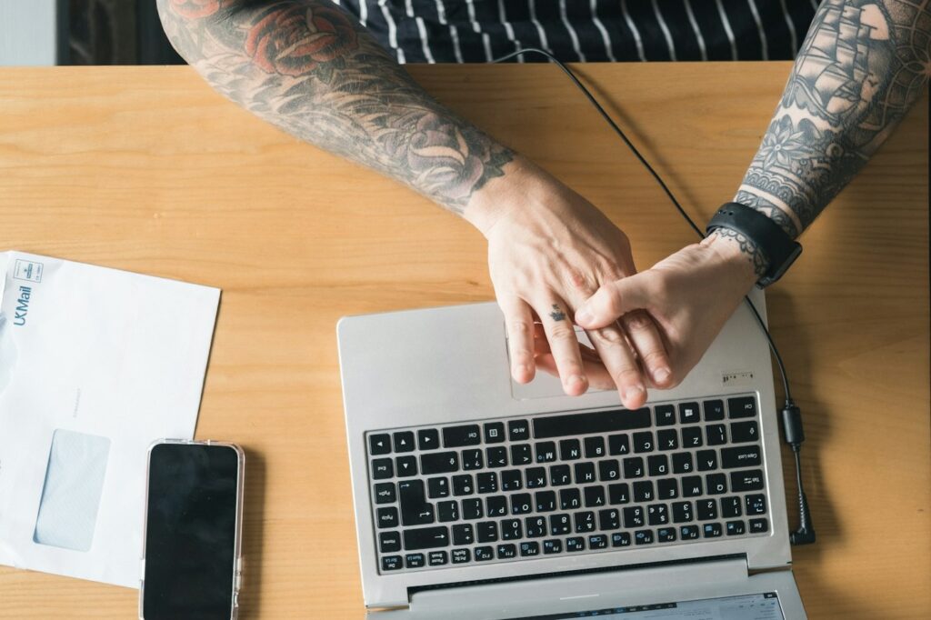 Sleeve tattoo on a man working at a laptop