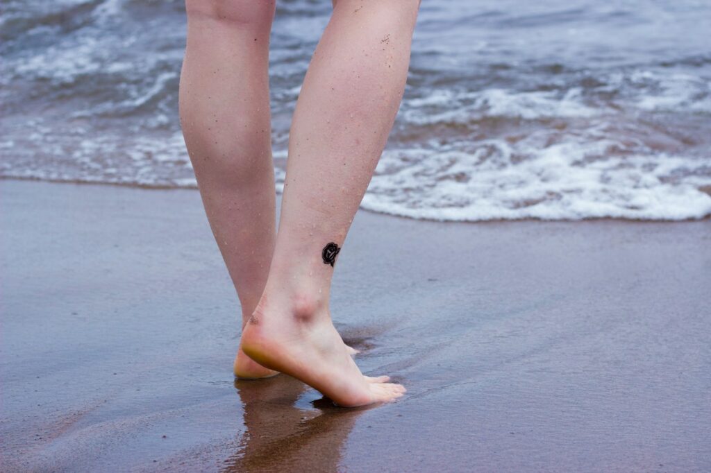 Small ankle tattoo on a beach