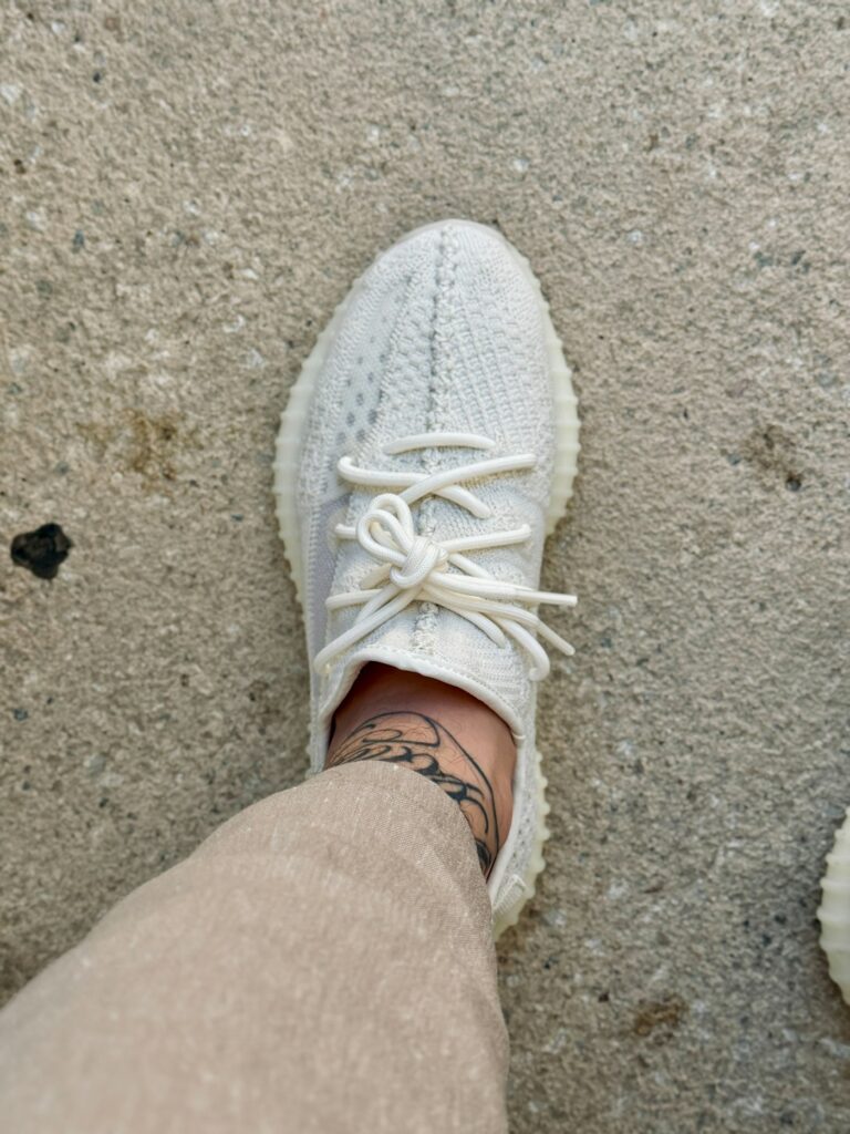 Small ankle tattoo above a white sneaker
