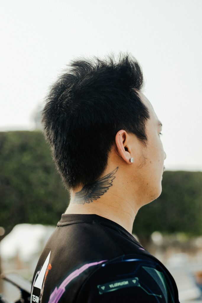 Small tattoo behind a man's ear