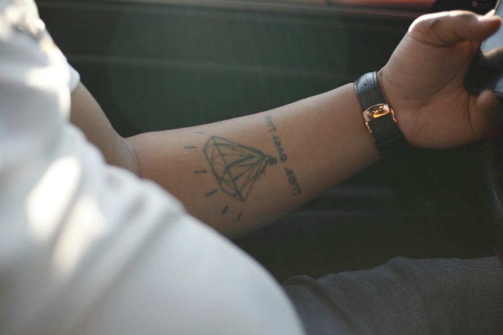 Wrist tattoos for men: small black symbol on the inner wrist